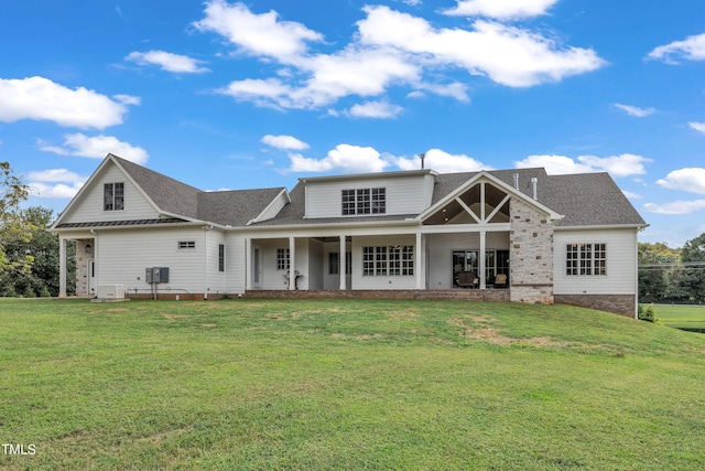 back of house with a lawn