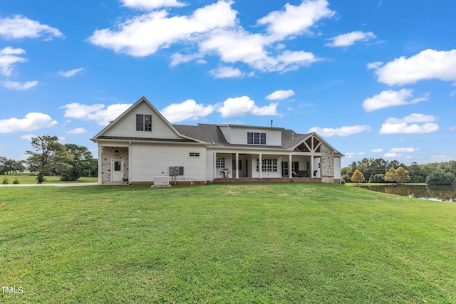 view of front facade with a front lawn, central AC unit, and a water view