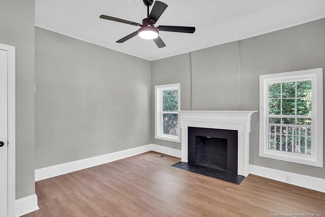 unfurnished living room featuring hardwood / wood-style floors and ceiling fan