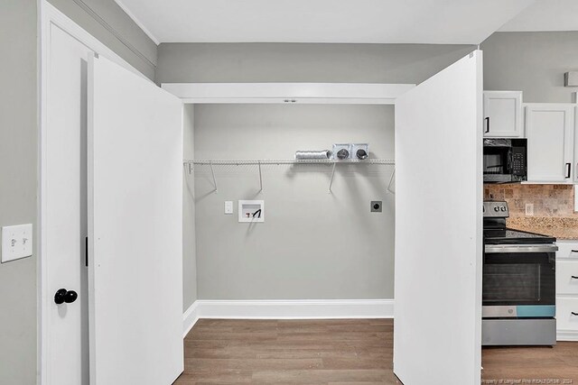 laundry room featuring washer hookup, wood-type flooring, and electric dryer hookup