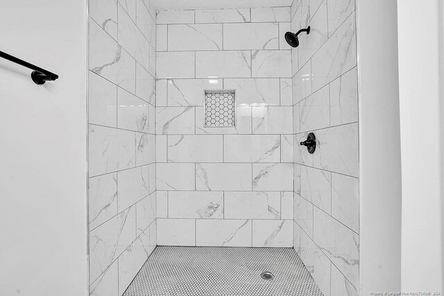 bathroom with tiled shower