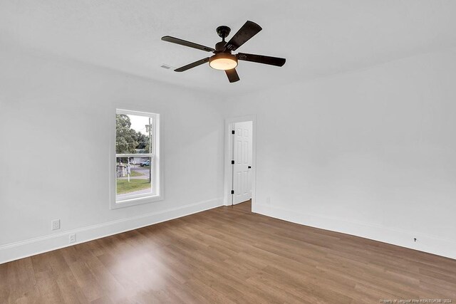 spare room with ceiling fan and dark hardwood / wood-style floors