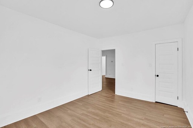 spare room with light hardwood / wood-style floors