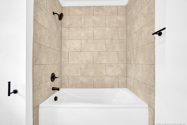 bathroom featuring tiled shower / bath and ornamental molding