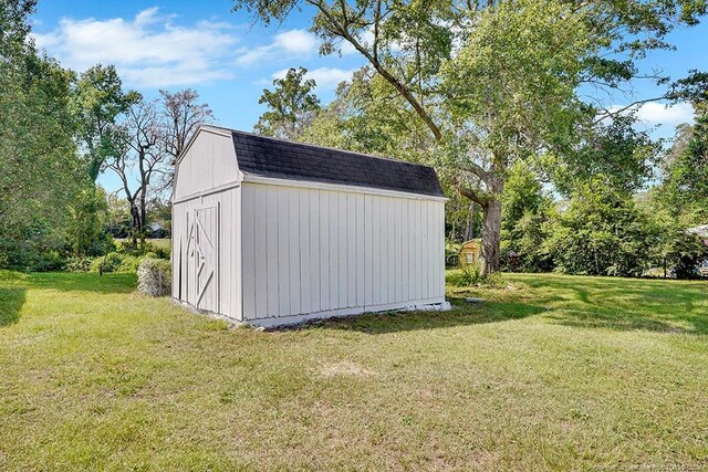 view of outbuilding featuring a yard