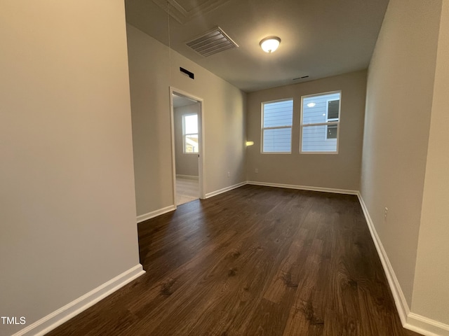 empty room featuring dark hardwood / wood-style flooring