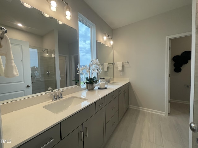 321 Murray Grey Ln, Wake Forest, NC 27587 - bathroom with a tile shower, double vanity, and baseboards