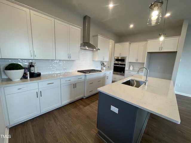 321 Murray Grey Ln, Wake Forest, NC 27587 - kitchen featuring a sink, wall chimney range hood, stainless steel appliances, dark wood finished floors, and white cabinetry