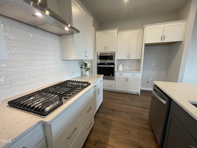 321 Murray Grey Ln, Wake Forest, NC 27587 - kitchen featuring stainless steel appliances, wall chimney range hood, backsplash, light stone counters, and white cabinetry