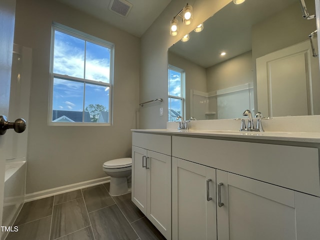 321 Murray Grey Ln, Wake Forest, NC 27587 - bathroom featuring toilet, baseboards, double vanity, recessed lighting, and a tub