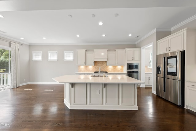 kitchen with dark wood-type flooring, stainless steel appliances, and a center island with sink