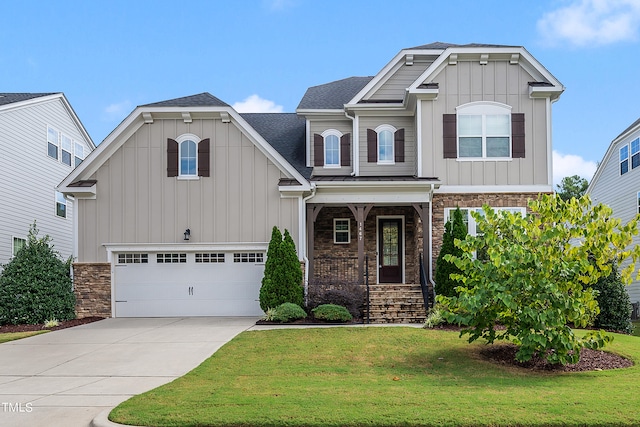 craftsman-style home featuring covered porch, a front lawn, and a garage