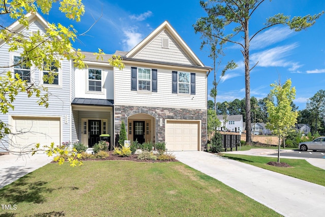 traditional-style home featuring a front lawn, concrete driveway, a garage, stone siding, and a standing seam roof