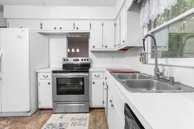 kitchen with white fridge, stainless steel electric stove, white cabinets, and sink