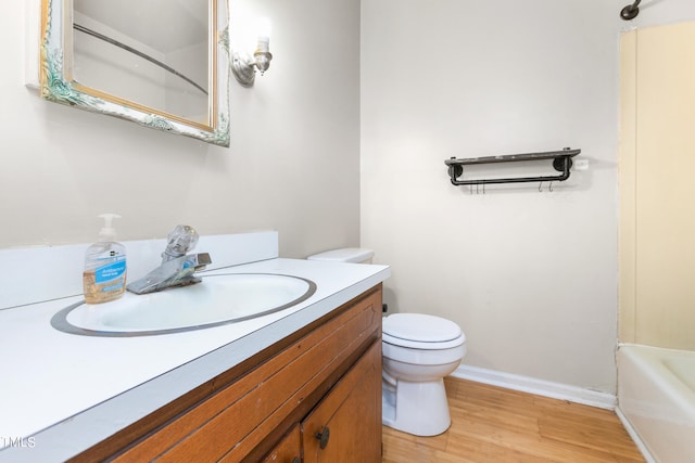 full bathroom with shower / bathing tub combination, vanity, toilet, and wood-type flooring