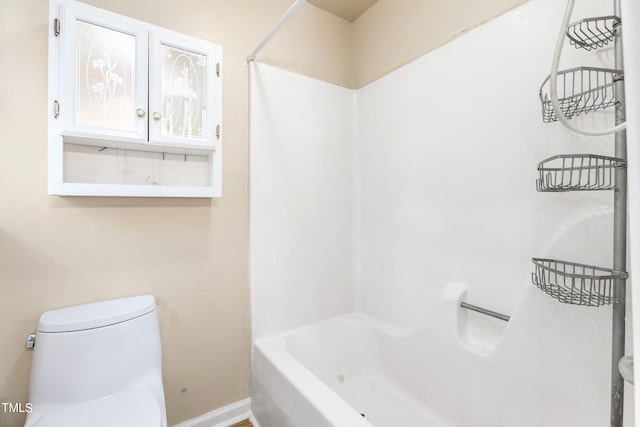 bathroom featuring toilet and shower / bath combination