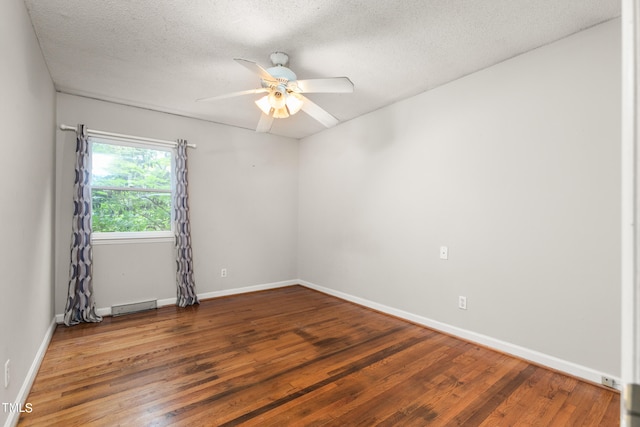 unfurnished room featuring ceiling fan, a baseboard radiator, dark hardwood / wood-style flooring, and a textured ceiling