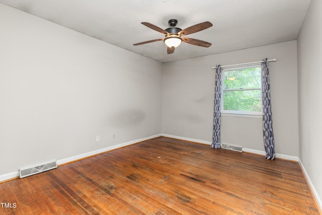 unfurnished room with a textured ceiling, ceiling fan, and wood-type flooring