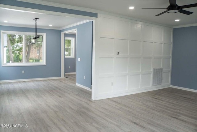 interior space with ceiling fan, ornamental molding, and light hardwood / wood-style flooring