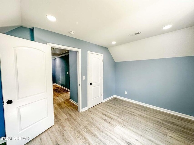 bonus room with light wood finished floors, visible vents, baseboards, vaulted ceiling, and recessed lighting