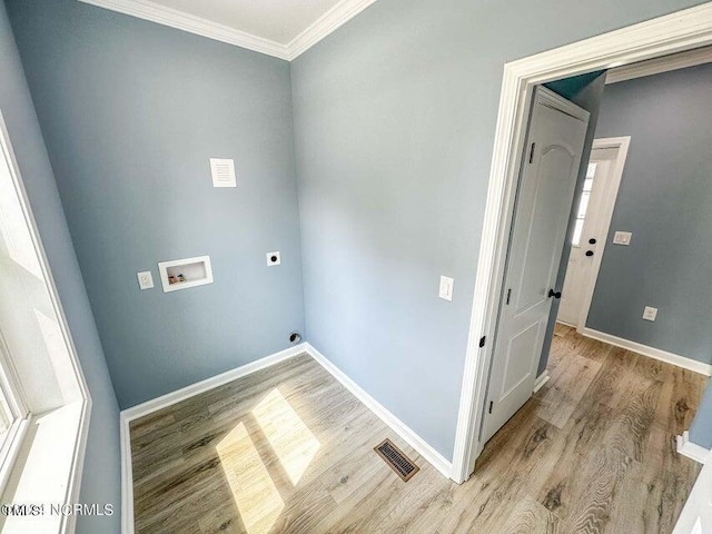 clothes washing area featuring electric dryer hookup, visible vents, ornamental molding, light wood-style flooring, and hookup for a washing machine