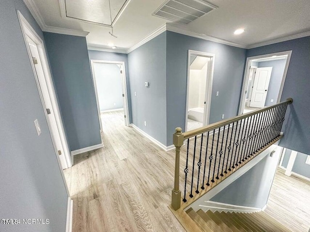 corridor with crown molding and light hardwood / wood-style flooring