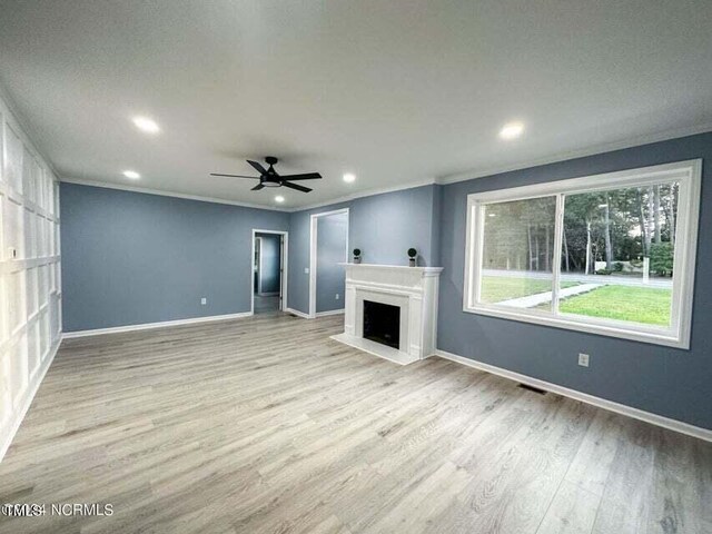 unfurnished living room featuring ceiling fan, light hardwood / wood-style floors, crown molding, and a textured ceiling