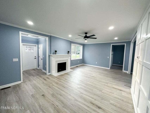 unfurnished living room featuring ornamental molding, a textured ceiling, light hardwood / wood-style flooring, and ceiling fan