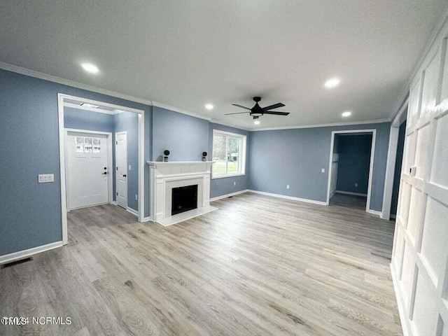 unfurnished living room with visible vents, baseboards, light wood-style flooring, and a fireplace