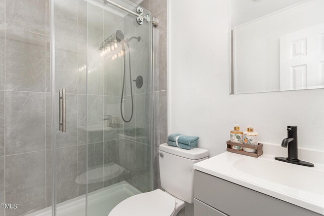 bathroom with vanity, toilet, and an enclosed shower