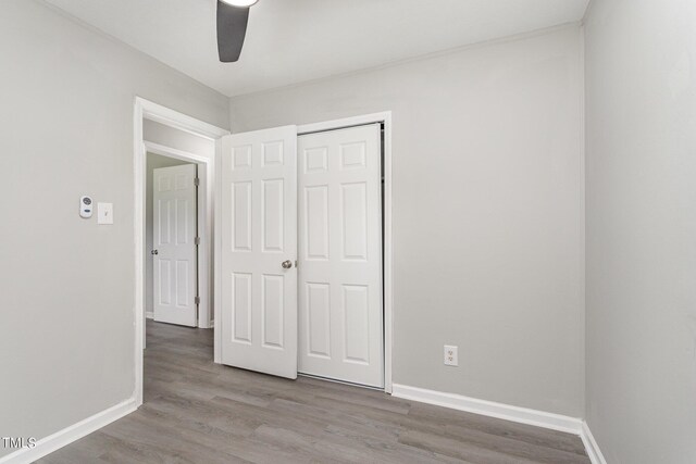 unfurnished bedroom with a closet, ceiling fan, and light hardwood / wood-style flooring