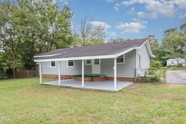 back of property featuring a yard and a patio