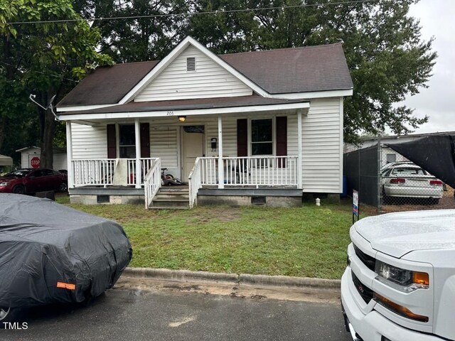 bungalow-style home featuring a front lawn and a porch