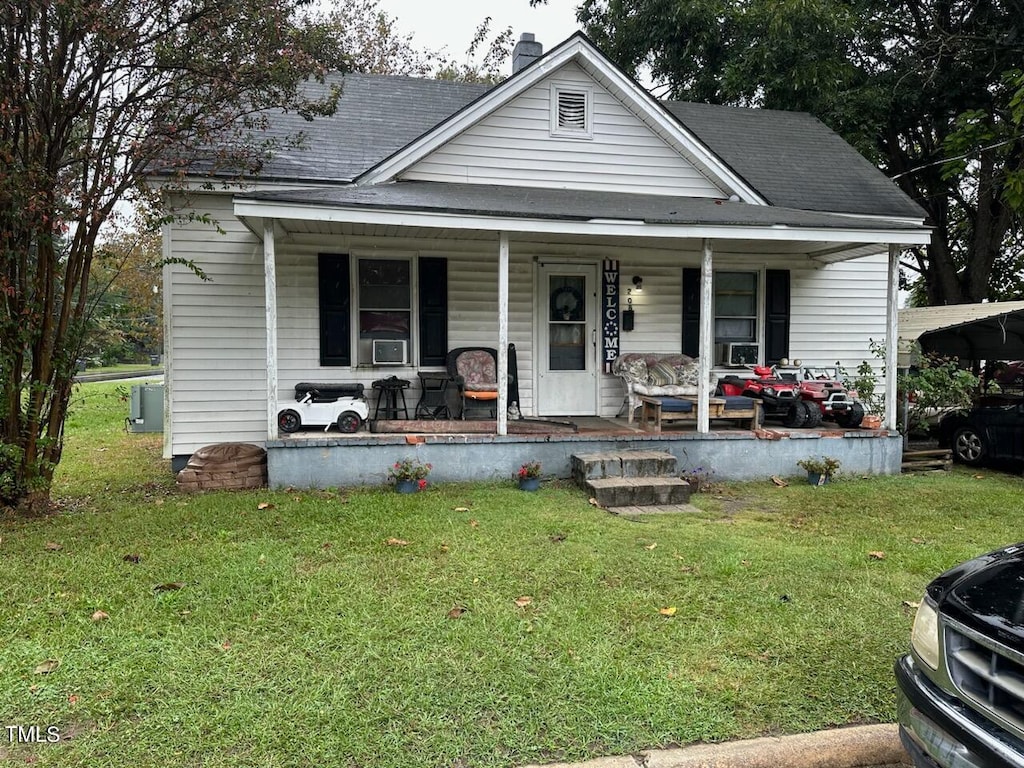 view of front of house featuring a front lawn and covered porch