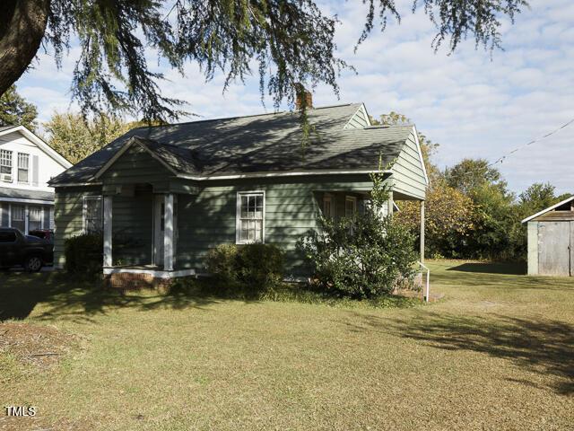 715 E Broad St, Fuquay Varina, NC 27526 - view of front of property with a front yard and a chimney