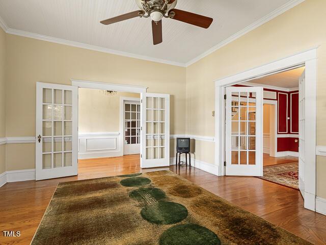 715 E Broad St, Fuquay Varina, NC 27526 - spare room with french doors, wood finished floors, crown molding, and a ceiling fan