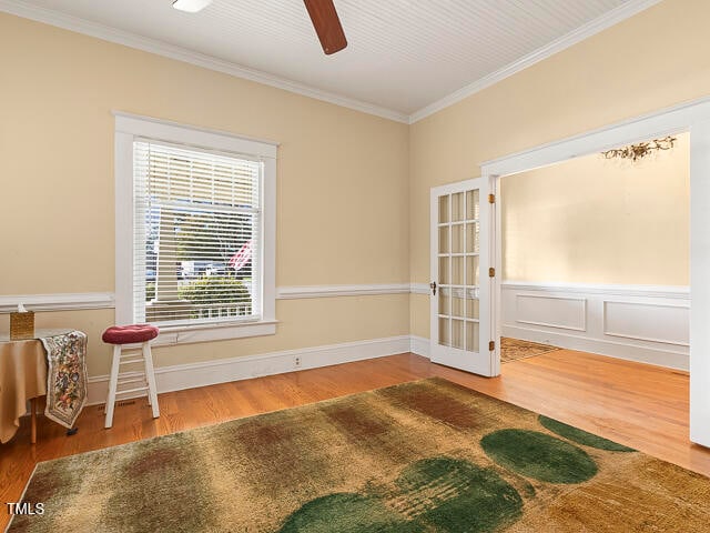 empty room featuring hardwood / wood-style flooring, ceiling fan, and ornamental molding