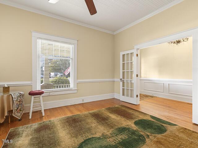 715 E Broad St, Fuquay Varina, NC 27526 - spare room with wood finished floors, ornamental molding, a ceiling fan, and baseboards