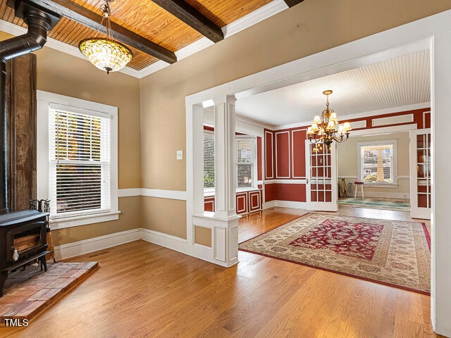 foyer entrance featuring hardwood / wood-style flooring, beamed ceiling, wooden ceiling, and plenty of natural light