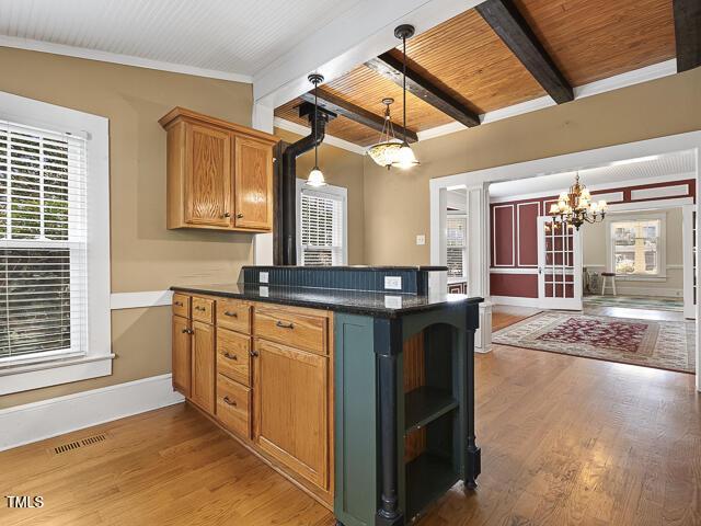 715 E Broad St, Fuquay Varina, NC 27526 - kitchen featuring a chandelier, a peninsula, dark countertops, beam ceiling, and open shelves