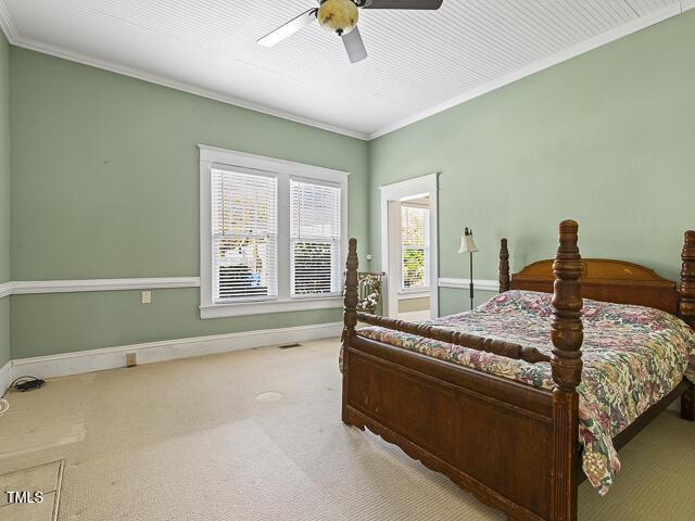 715 E Broad St, Fuquay Varina, NC 27526 - carpeted bedroom with crown molding, baseboards, and a ceiling fan