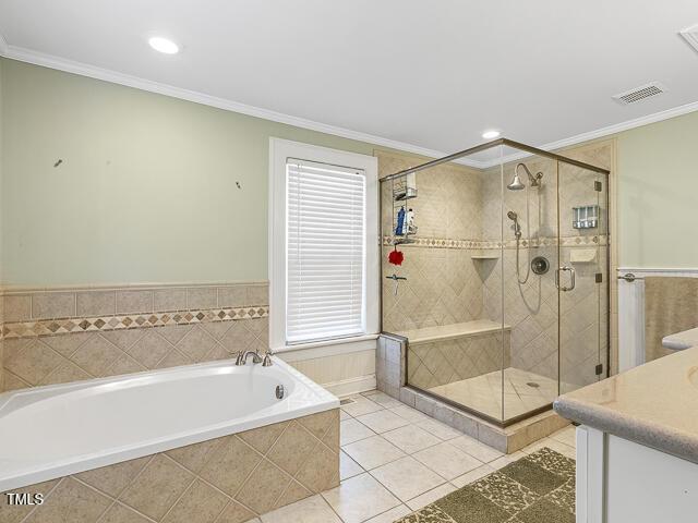 715 E Broad St, Fuquay Varina, NC 27526 - bathroom featuring a garden tub, crown molding, a shower stall, tile patterned floors, and recessed lighting