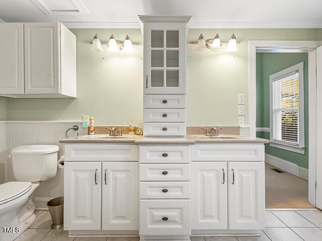 bathroom featuring toilet, vanity, and tile patterned floors