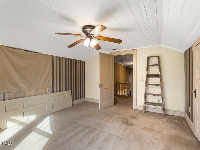 interior space featuring ceiling fan, wood ceiling, and lofted ceiling