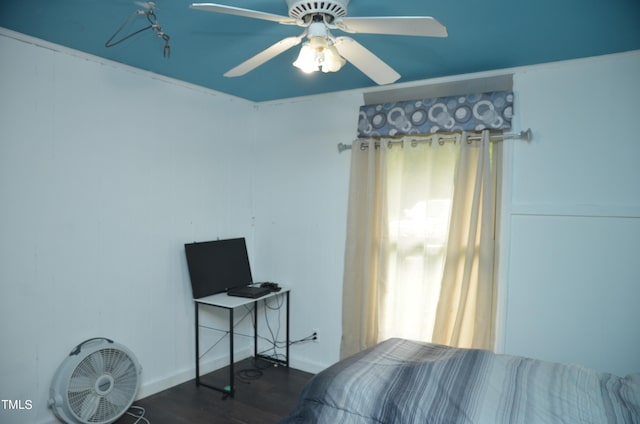 bedroom with ceiling fan, dark hardwood / wood-style floors, and multiple windows