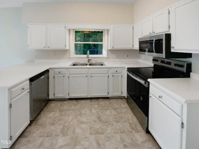 kitchen featuring stainless steel appliances, white cabinetry, and sink