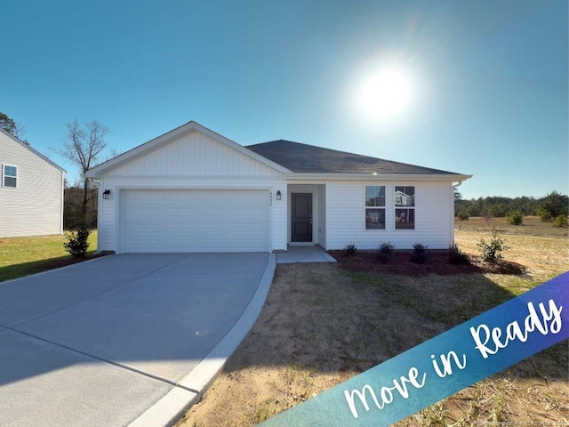 ranch-style house with a garage and driveway