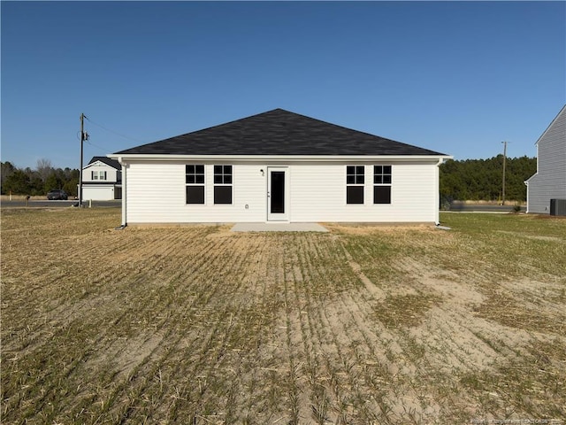 rear view of house featuring central AC unit and a patio