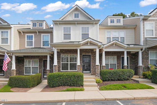 townhome / multi-family property with a porch