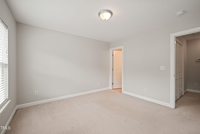 unfurnished bedroom with light colored carpet